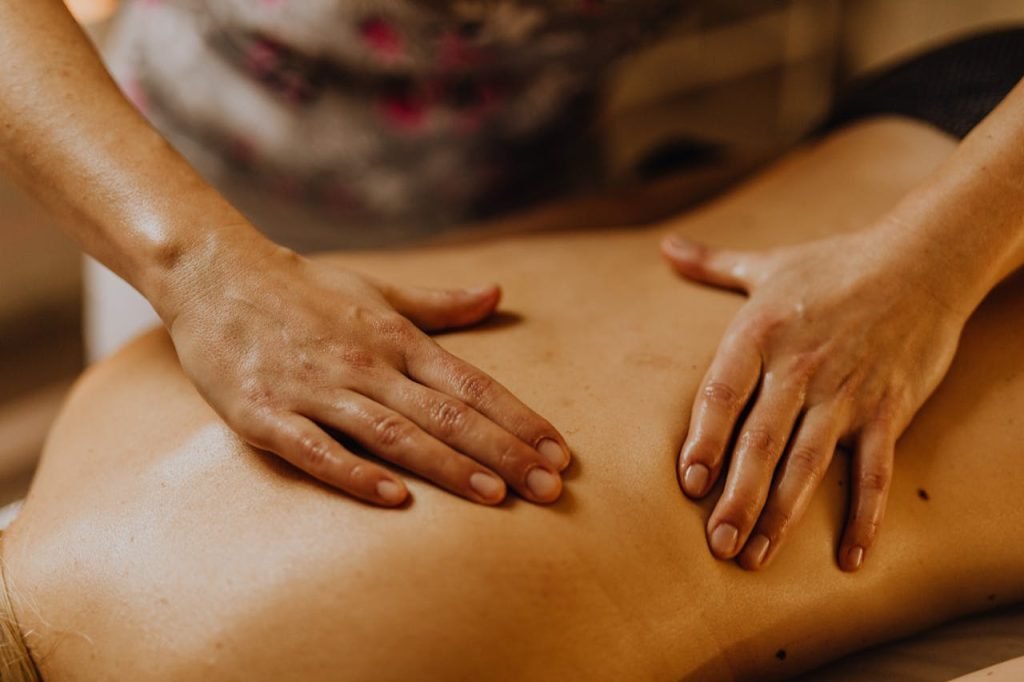 Therapist massaging person's back